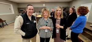 Men and women attending the Hudson Behavioral Health ribbon cutting