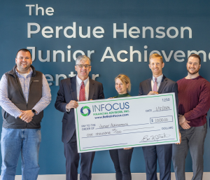 five people holding a large check at The Perdue Henson Junior Achievement