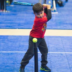 Little boy swinging a baseball bat