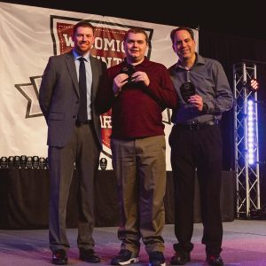 Youth Sportsmanship and Outstanding Coach Award recipients from Little League Challenger, Dylan Freeman and Bob Freeman, accept their award from Recreation Superintendent James Simmons.