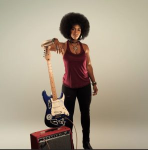 African American female holding an electric guitar
