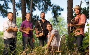 Band playing instruments in the woods