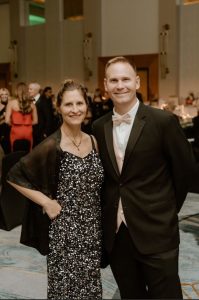 Husband and wife dressed up at a formal event