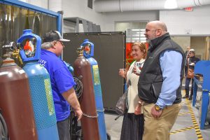 Men gathering around a welding station at Wor-Wic