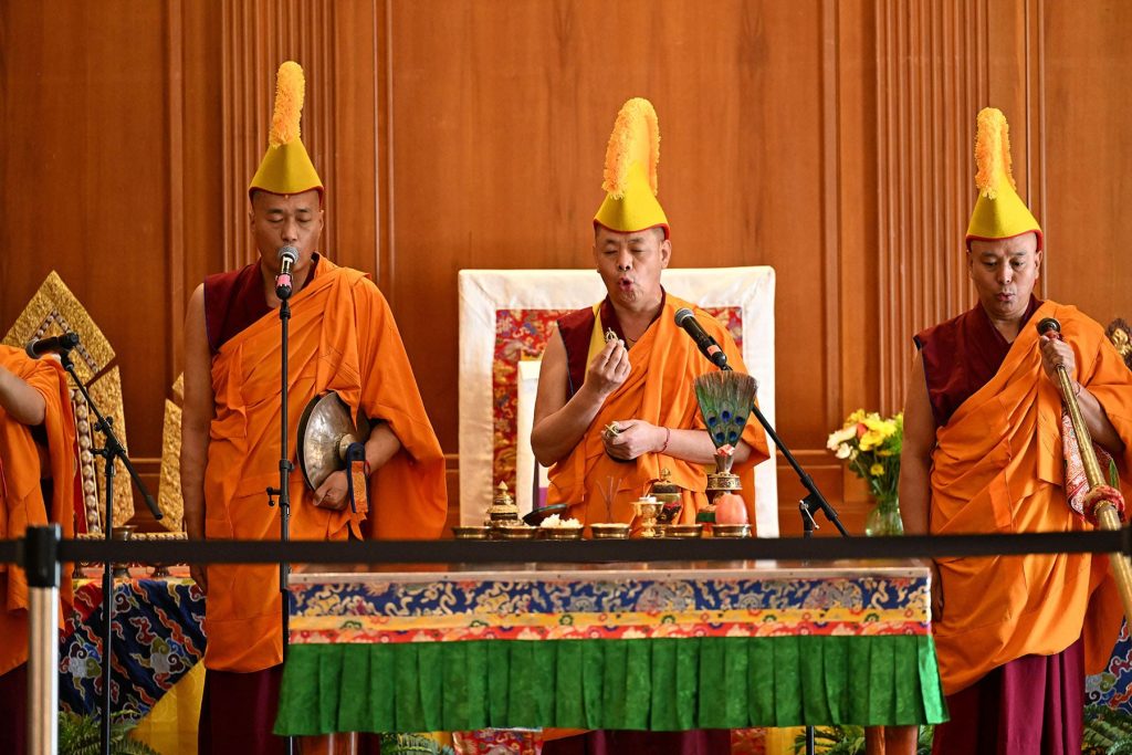 Three monks with headgear at SU