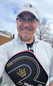 Older man playing pickleball