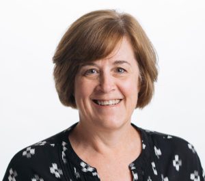 Headshot of an older women against a blank background