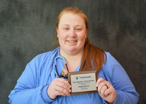 young female healthcare worker in blue scrubs