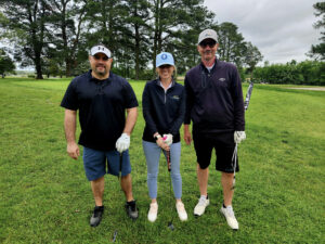 3 Golfers standing on a golf course