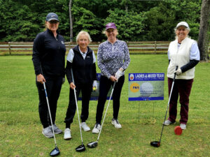 Group of ladies holding golf clubs