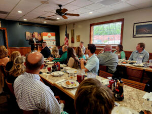 Group of people listening to a man present