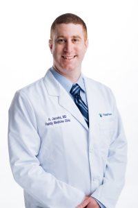 Headshot of a doctor in a white lab coat