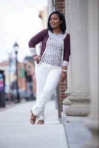 female standing against a wall