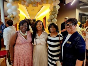 women at a ribbon cutting event