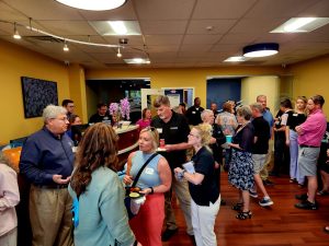 Large group of people gathering for an indoor event