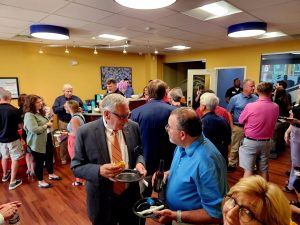 Large group of people gathering for an indoor event