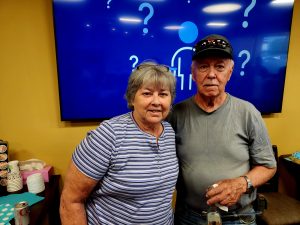 Two people at a ribbon cutting event