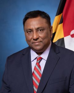 Headshot of Sanjay Rai in a suit and tie
