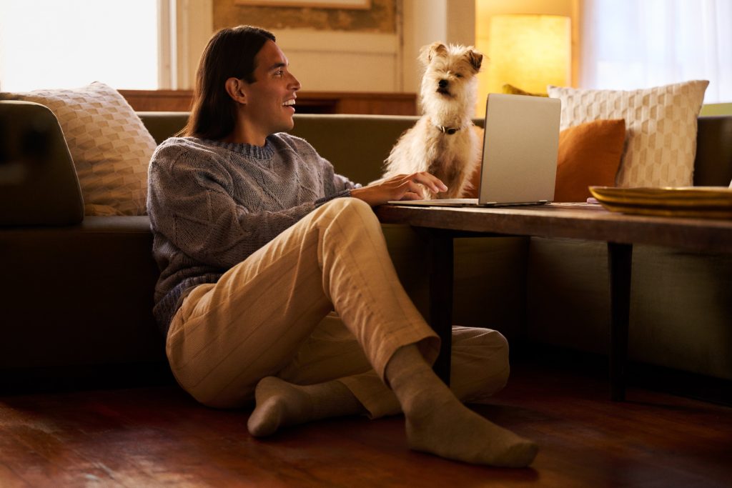 Man watching a movie with his dog