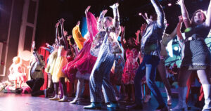 Large group of people dancing on stage