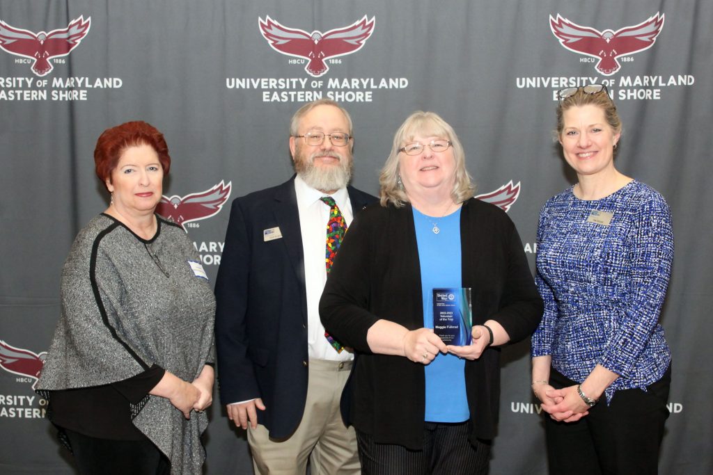 Group of people holding an award