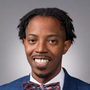 Headshot of a young man in a bow tie