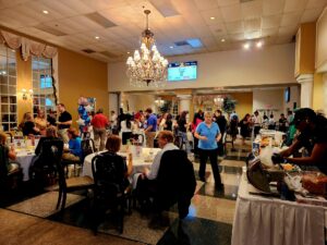 Banquet room filled with people sitting at tables conversing