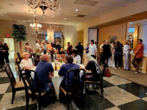 Banquet room filled with people sitting at tables conversing