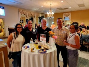 Group of 5 people standing at a table