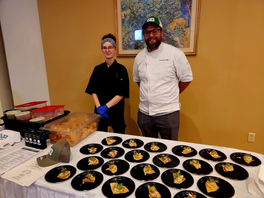 Green Hill Country Club served a unique and tasty dish of Corn Dip Tortilla Chips topped with marinated crab, pickled shallots, and jalapenos.
