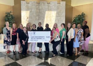 Group of women holding a large check