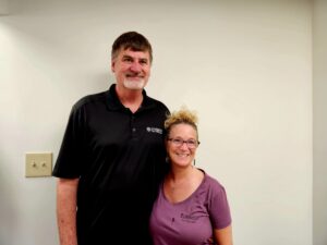 Male and female attending a ribbon cutting event