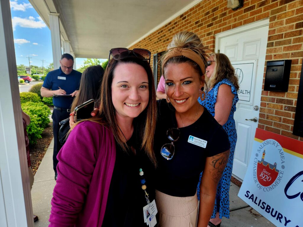 two females at a ribbon cutting event