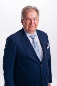 Headshot of a man in a suit and tie