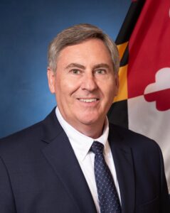 Headshot of a man in a suit and tie