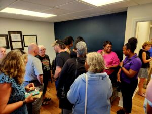 People gathering at a ribbon cutting ceremony