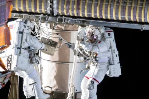 two astronauts doing a spacewalk