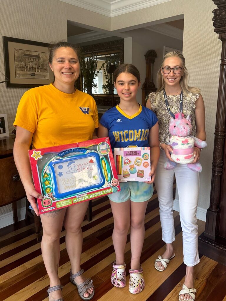 three young girls holding toys