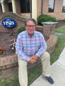 Hebron Savings Bank banker sitting outside