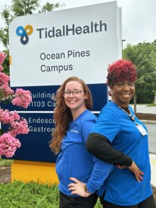 two female nurses standing back to back