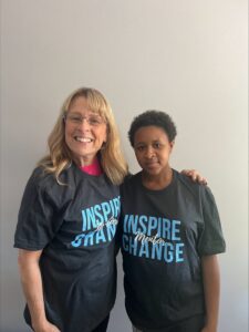 two women standing together in matching t-shirts