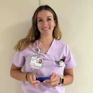 Headshot of a young female nurse in pink scrubs