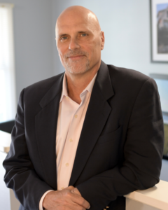 Headshot of a man in a suit