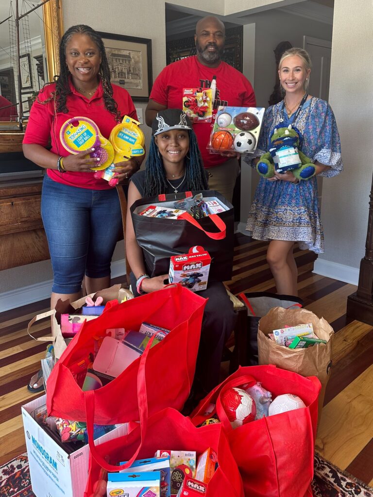 four people surrounded by toys