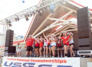 Group of people standing on a stage cheering