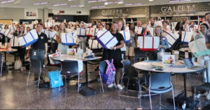 Large group of teachers holding handbags