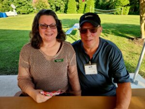 Smiling people sitting outside at the chamber mixer