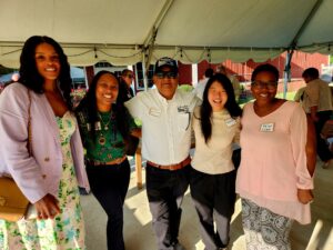 Group of 5 people standing outside under a tent at the chamber mixer