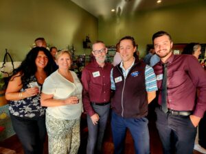 Group of smiling people indoors at the chamber mixer