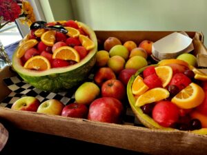 Watermelon bowl of fruit and tray of sliced fruits